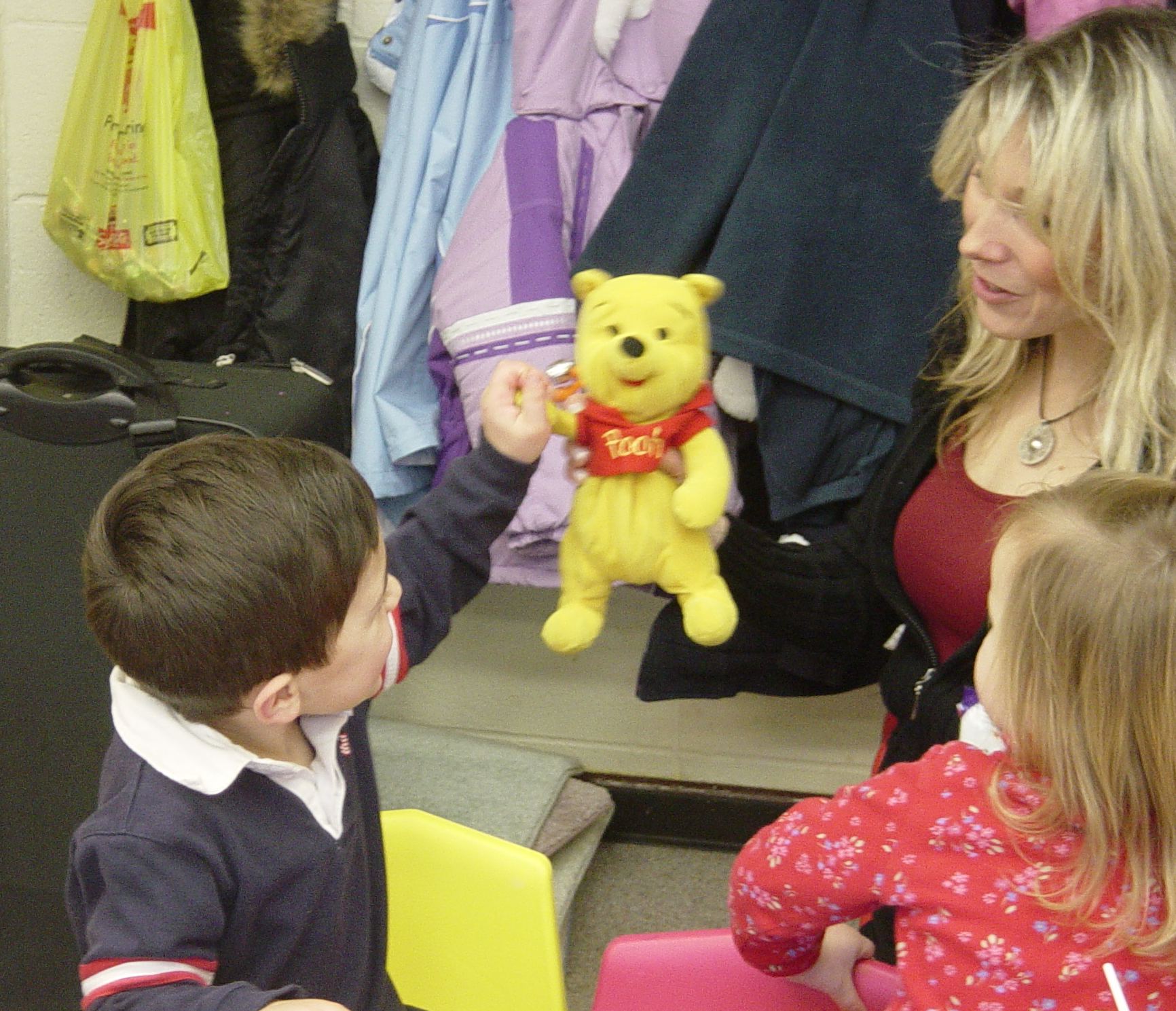 Teacher talking through Pooh Bear to small child